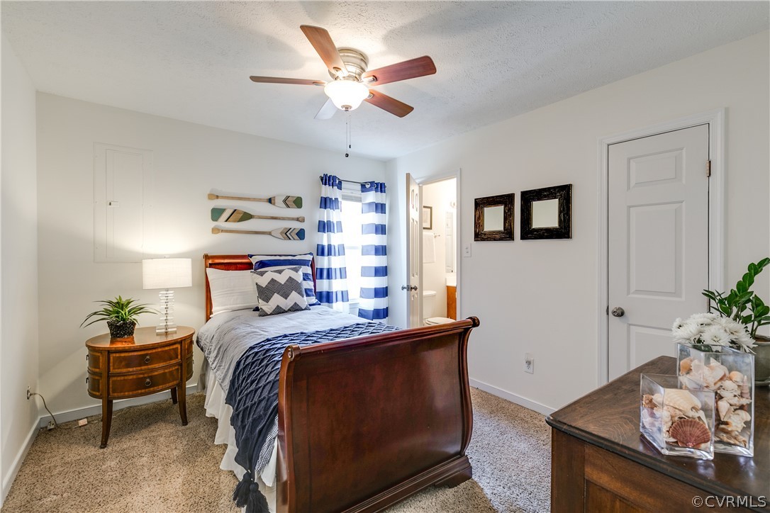 13835 Happy Hill Road Chester, VA 23831 - Photo 20 of 35 a bedroom with a bed and a chandelier