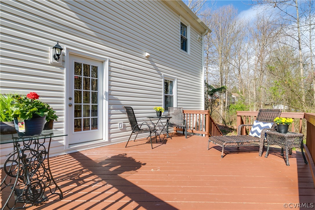 13835 Happy Hill Road Chester, VA 23831 - Photo 28 of 35 a view of a patio with a dining table and chairs with wooden fence