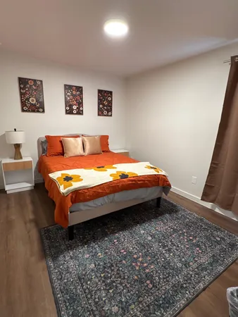 a bed sitting in a bedroom next to a window