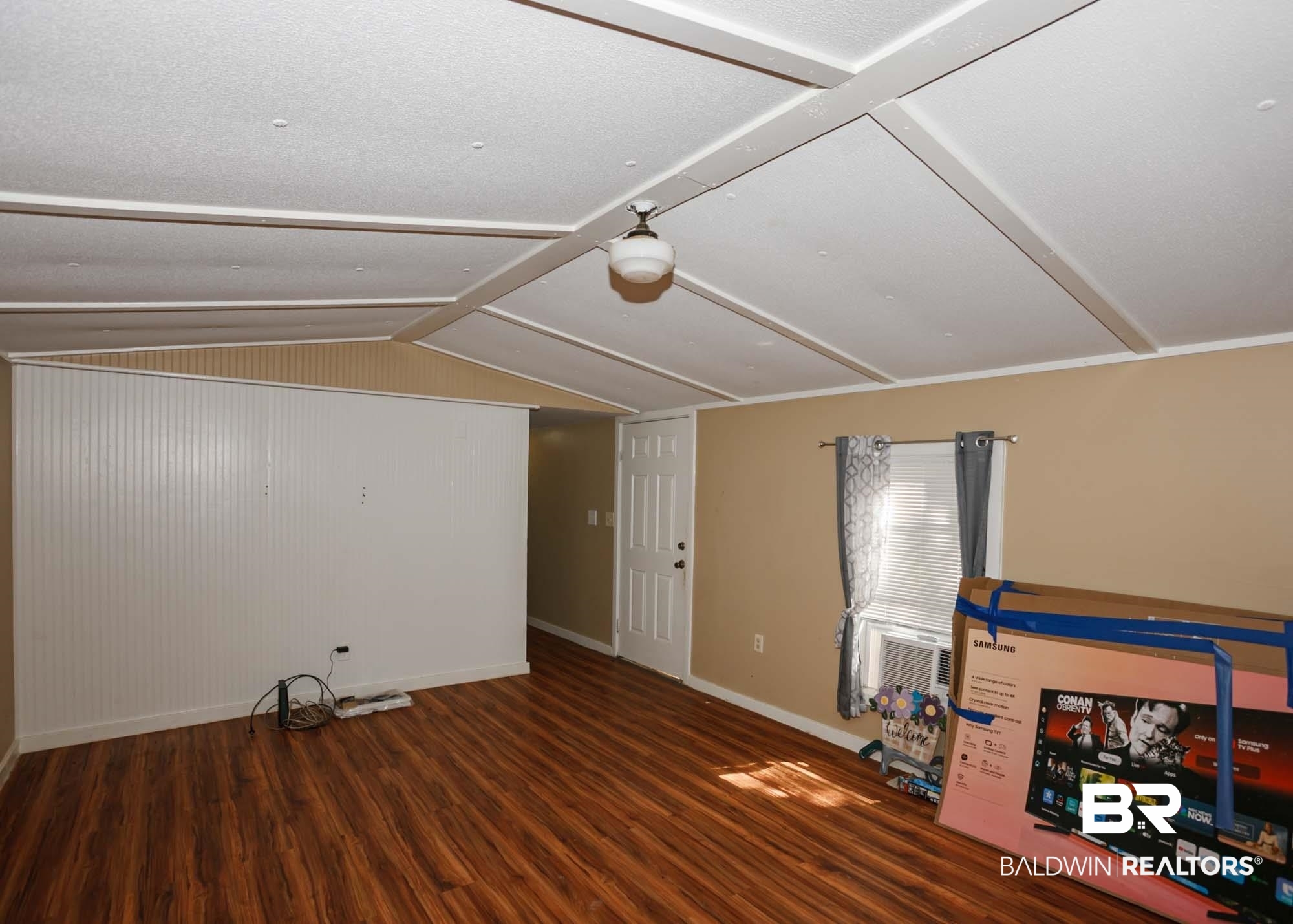 11998 Workman Avenue Foley, AL 36535 - Photo 43 of 59 Unfurnished living room featuring wood finished floors and lofted ceiling