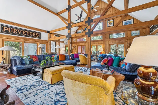 a living room with furniture a rug and a large window