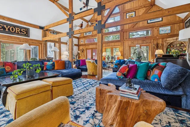 a living room with furniture and a floor to ceiling window