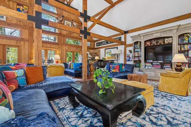 a living room with patio furniture and a flat screen tv