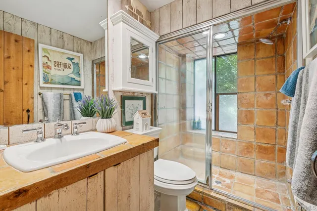 a bathroom with a sink toilet and shower