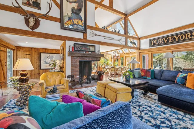 a living room with furniture fireplace and a large window