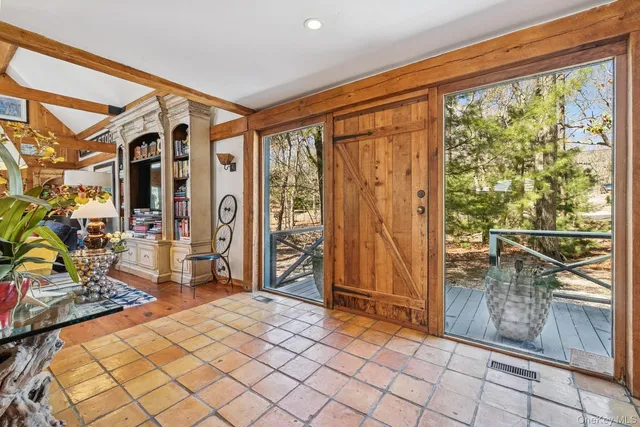 a bedroom with furniture and large window