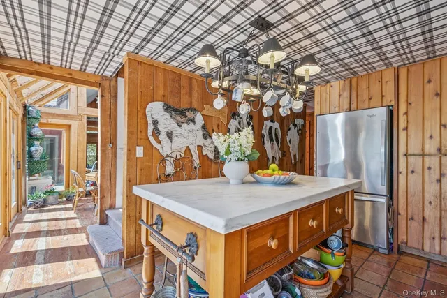 a view of a kitchen with a sink and refrigerator