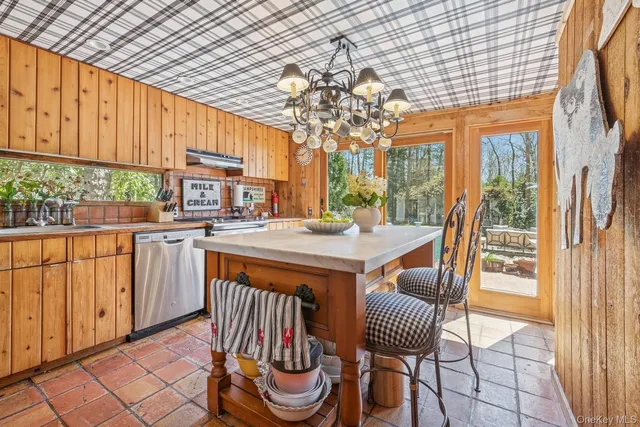 a dining room with furniture a chandelier and window