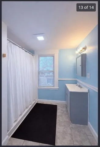 a view of a bathroom with a sink and mirror