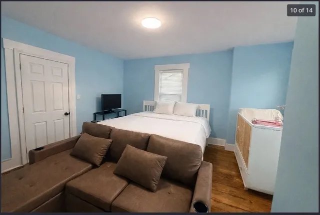 a bedroom with a bed and a couch