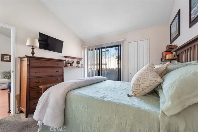 a bedroom with a bed and flat screen tv