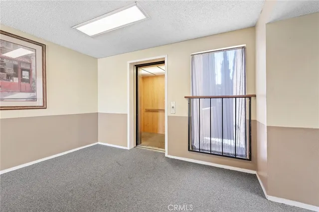 a view of an empty room with closet area