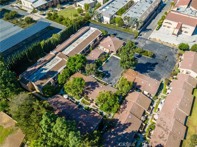 an aerial view of a house with a yard