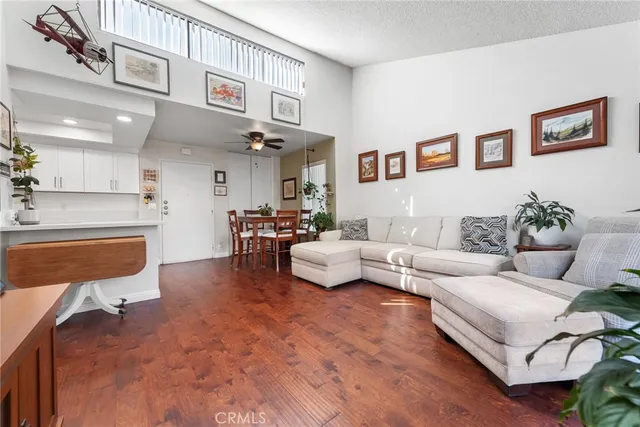 a living room with furniture and kitchen view