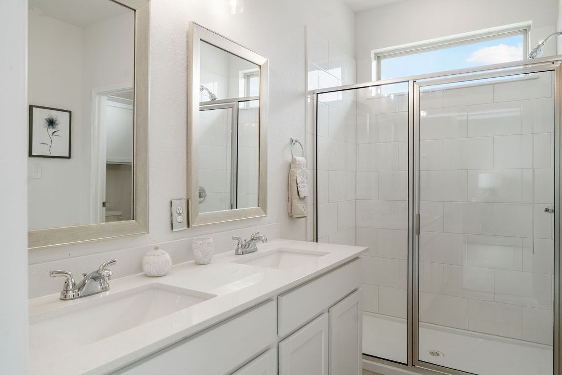 20604 A Haygrazer Way Pflugerville, TX 78660 - Photo 19 of 31 a bathroom with a shower sink and mirror
