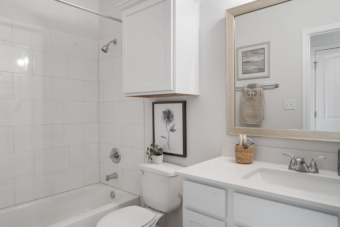 20604 A Haygrazer Way Pflugerville, TX 78660 - Photo 22 of 31 a bathroom with a sink a toilet and shower
