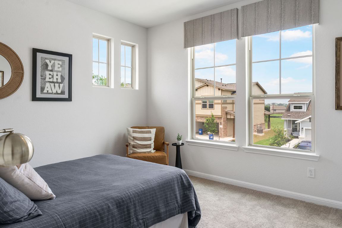 20604 A Haygrazer Way Pflugerville, TX 78660 - Photo 23 of 31 a bedroom with a bed and a window