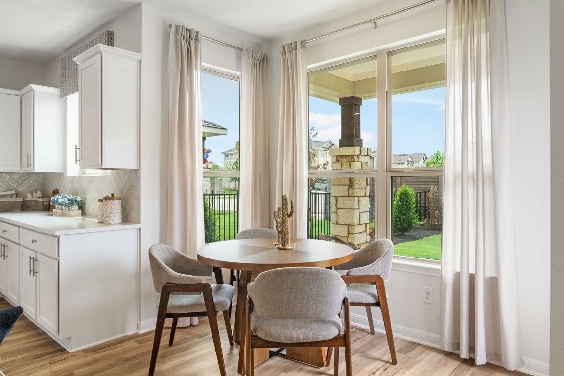 20604 A Haygrazer Way Pflugerville, TX 78660 - Photo 3 of 31 a view of a dining room with furniture and a window