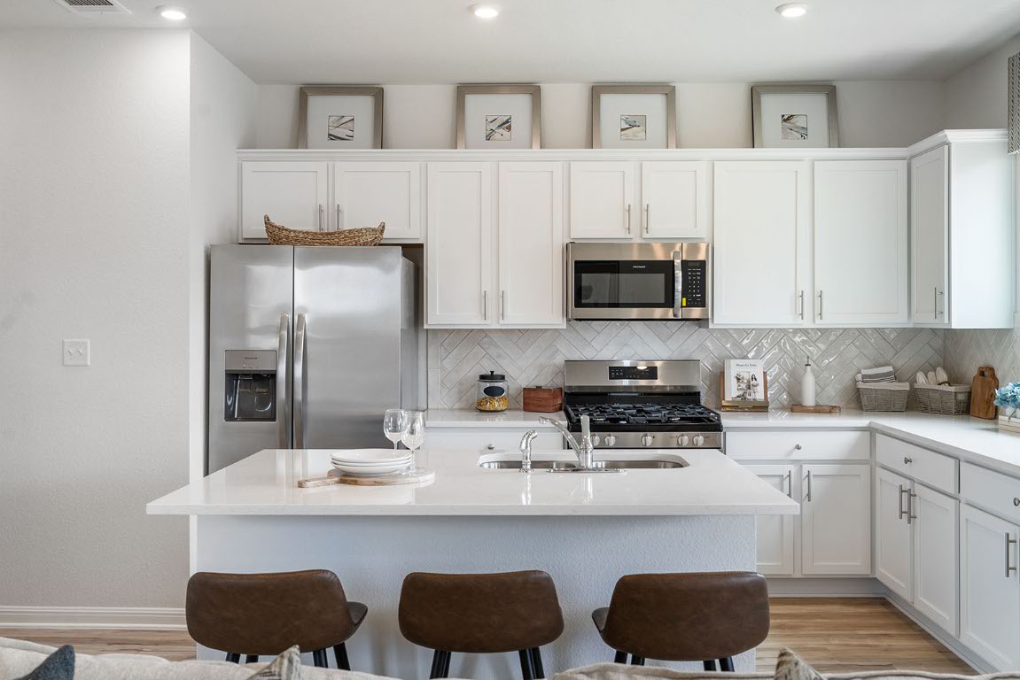 20604 A Haygrazer Way Pflugerville, TX 78660 - Photo 10 of 31 a kitchen with stainless steel appliances a stove a sink and a refrigerator