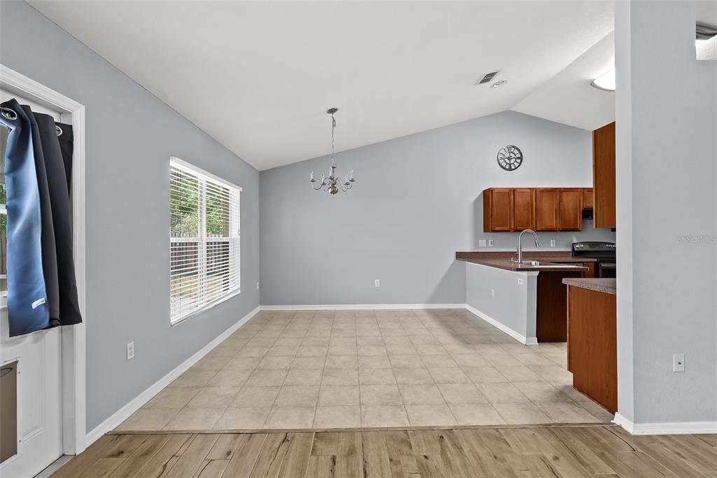 11366 Riddle Drive Spring Hill, FL 34609 - Photo 13 of 49 a kitchen with granite countertop a stove and a sink