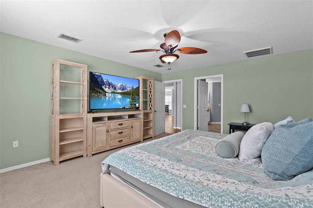 11366 Riddle Drive Spring Hill, FL 34609 - Photo 24 of 49 a bedroom with a bed and a flat screen tv
