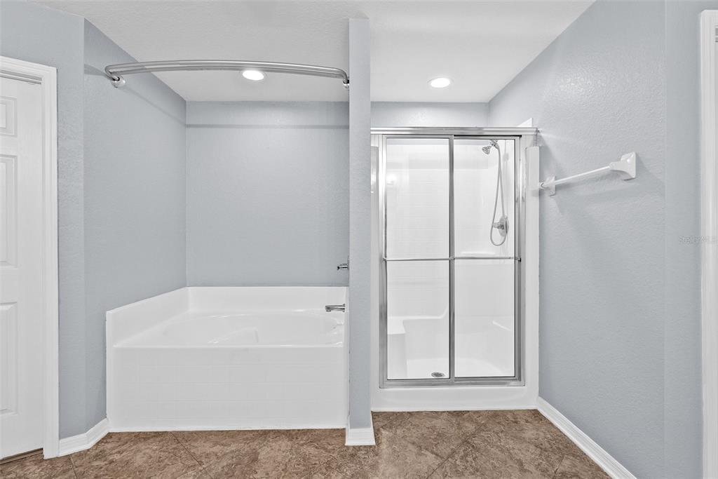 11366 Riddle Drive Spring Hill, FL 34609 - Photo 27 of 49 a bathroom with a tub and shower