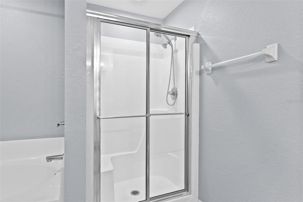 11366 Riddle Drive Spring Hill, FL 34609 - Photo 28 of 49 a bathroom with a glass shower door