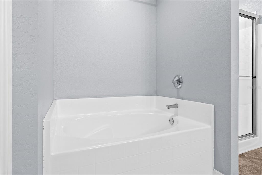 11366 Riddle Drive Spring Hill, FL 34609 - Photo 29 of 49 a white bath tub sitting in a bathroom