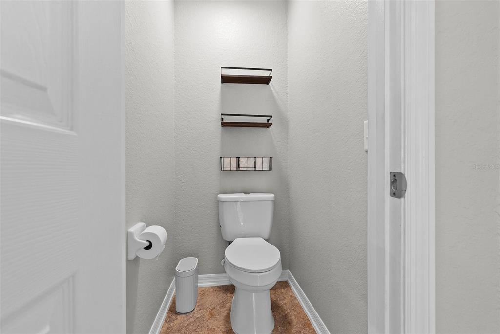 11366 Riddle Drive Spring Hill, FL 34609 - Photo 30 of 49 a bathroom with a toilet and a vanity