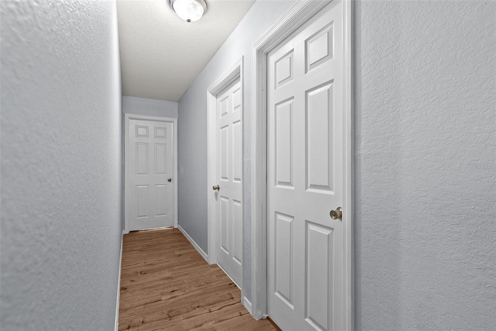 11366 Riddle Drive Spring Hill, FL 34609 - Photo 32 of 49 a view of a hallway with wooden floor and entryway