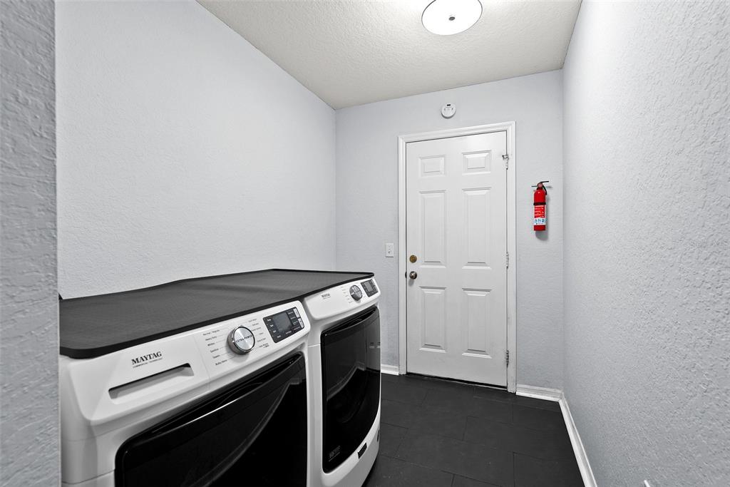 11366 Riddle Drive Spring Hill, FL 34609 - Photo 39 of 49 a utility room with dryer and washer