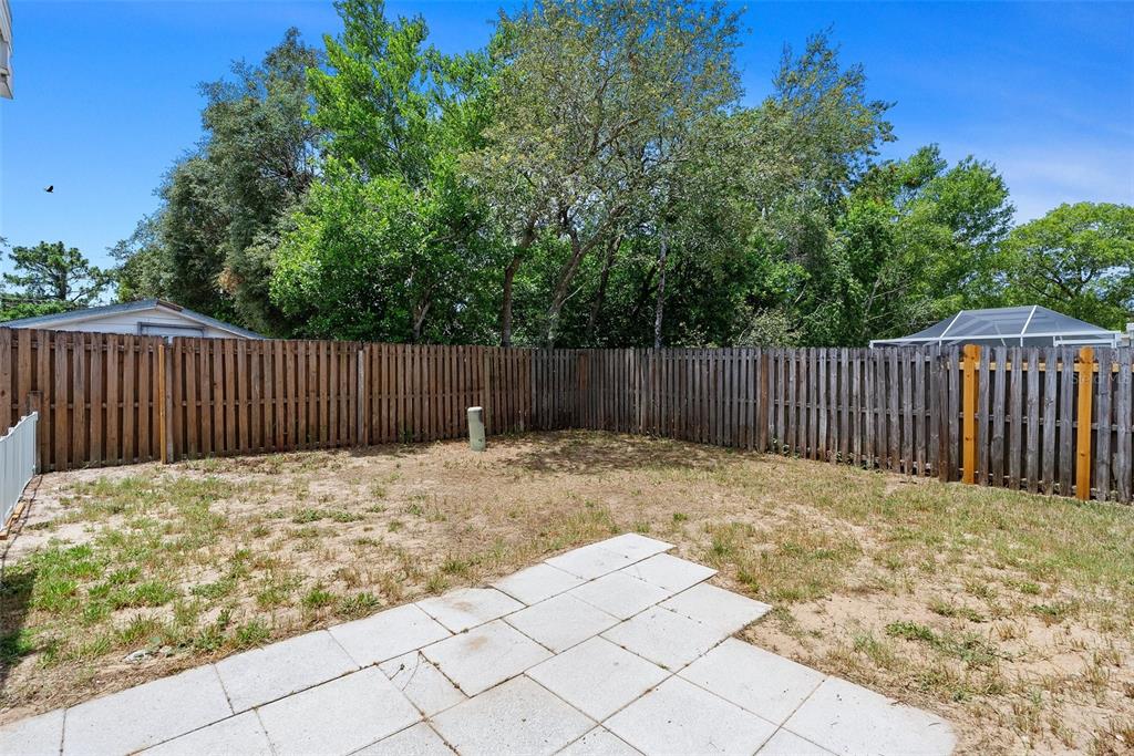 11366 Riddle Drive Spring Hill, FL 34609 - Photo 42 of 49 a white house covered with wooden fence
