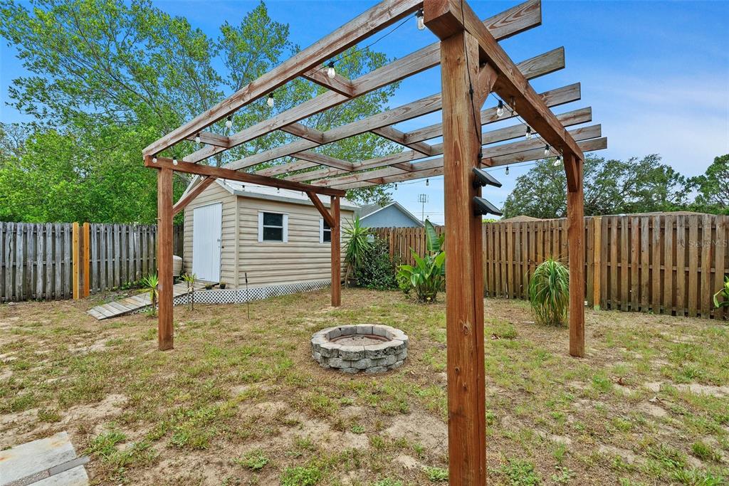11366 Riddle Drive Spring Hill, FL 34609 - Photo 43 of 49 a backyard of a house with table and chairs