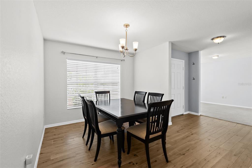 11366 Riddle Drive Spring Hill, FL 34609 - Photo 8 of 49 a view of a dining room with furniture window and wooden floor
