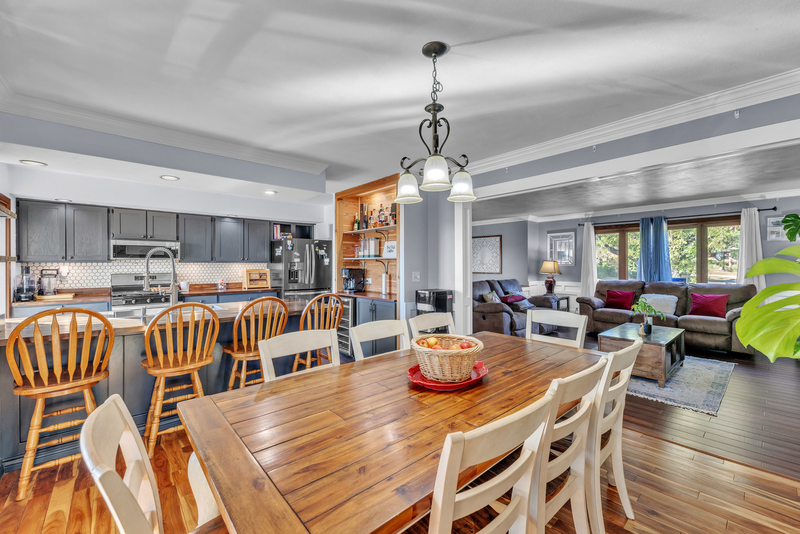 6338 Thicket Lane Cherry Valley, IL 61016 - Photo 8 of 43 a view of a dining room and livingroom with furniture wooden floor a chandelier