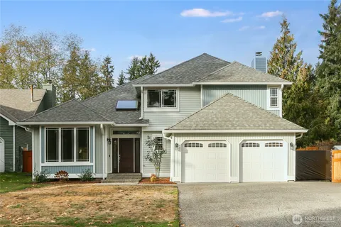 a front view of a house with a yard and garage