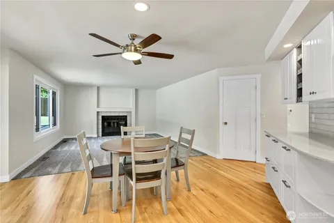 a living room with furniture a large window and a fireplace