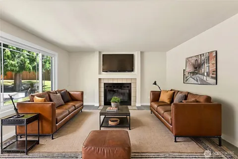a view of empty room with a fireplace and window