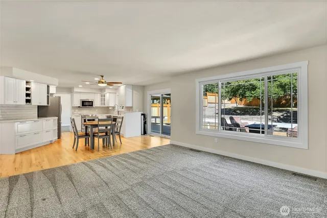a bathroom with a granite countertop toilet a sink and a mirror