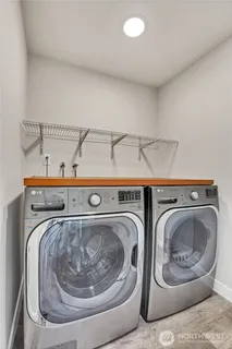 a bedroom with a bed and a flat tv screen on dresser