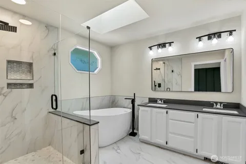 a white bath tub sitting next to a shower
