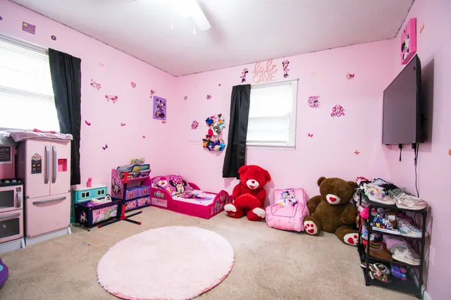 a bedroom with furniture and a flat screen tv