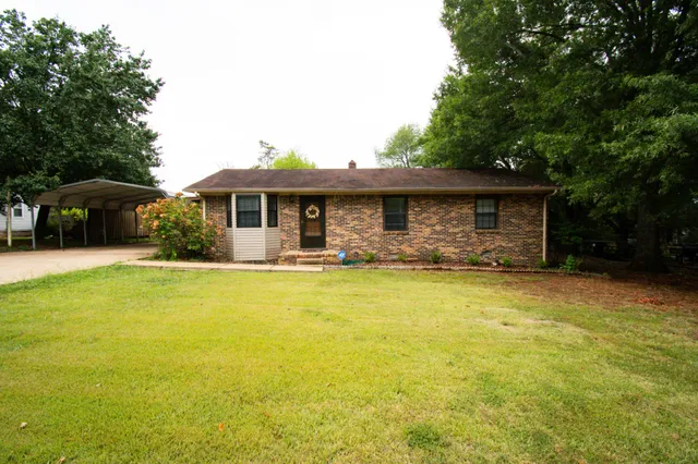 a front view of house with yard outdoor seating and barbeque oven