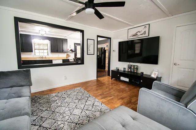 a living room with furniture and a flat screen tv