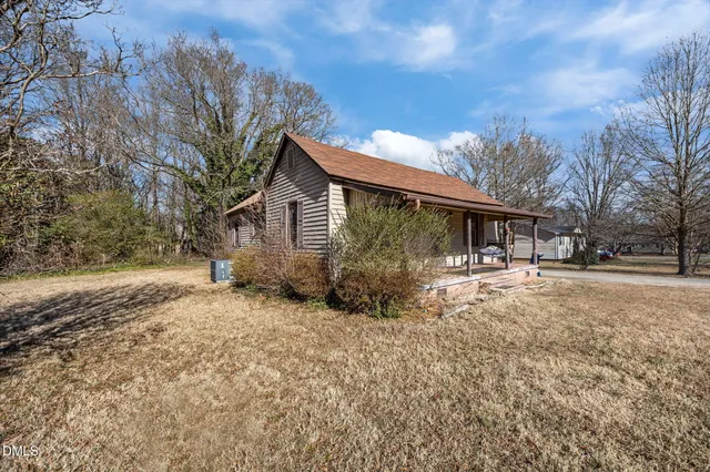 a view of a house with a yard covered in snow