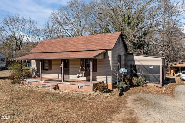 a backyard of a house with yard and outdoor seating
