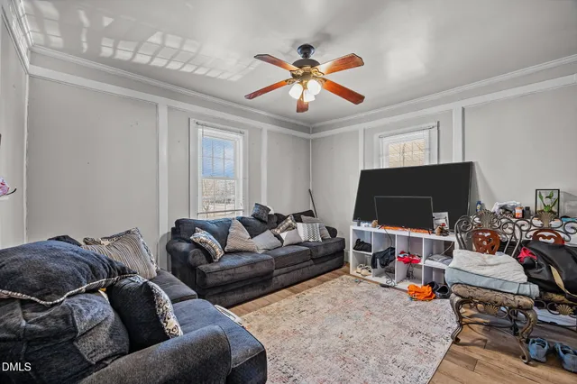 a living room with furniture a rug and a flat screen tv