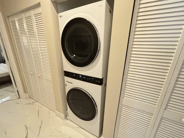 a view of a hallway with washer and dryer