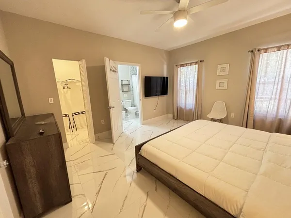 a bedroom with a bed and a flat screen tv