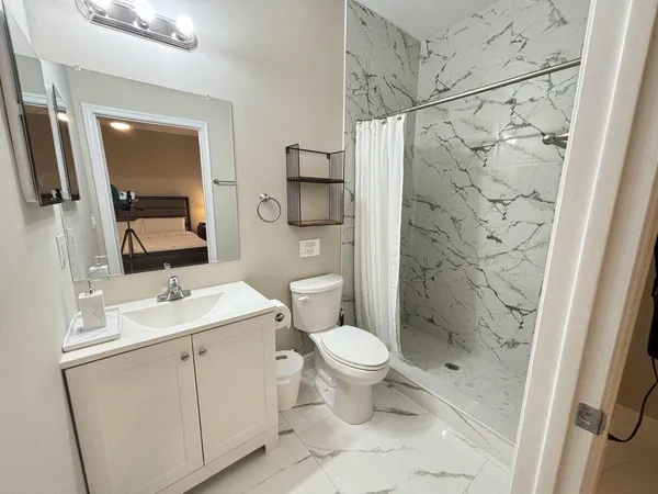 a bathroom with a sink toilet and shower